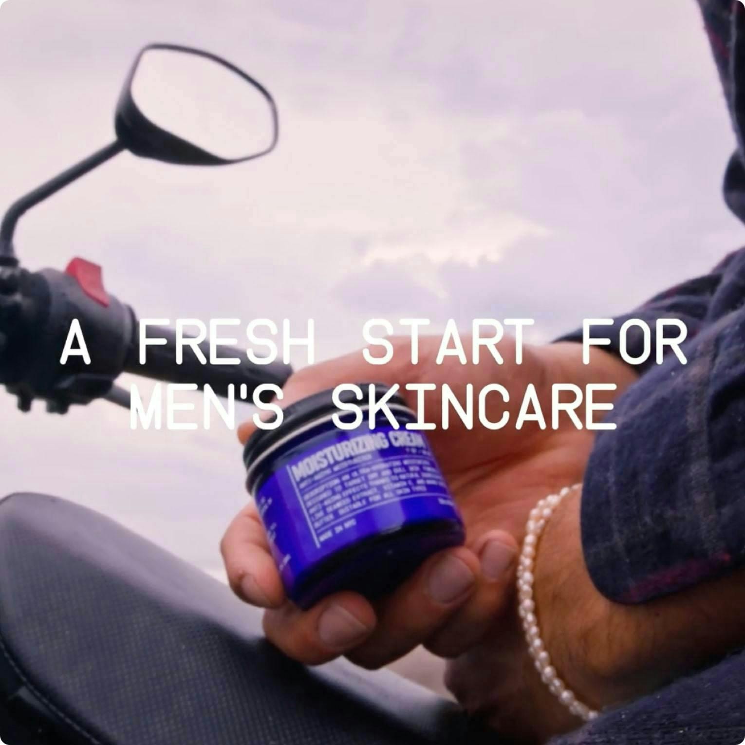 Close up of a man holding a Blu Atlas product on a motorcycle