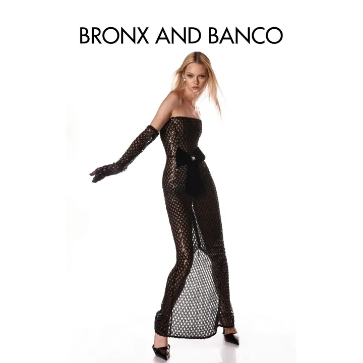 Bronx and Banco product ad: a model in a black sequin lattice gown with a velvet bow and matching gloves on white