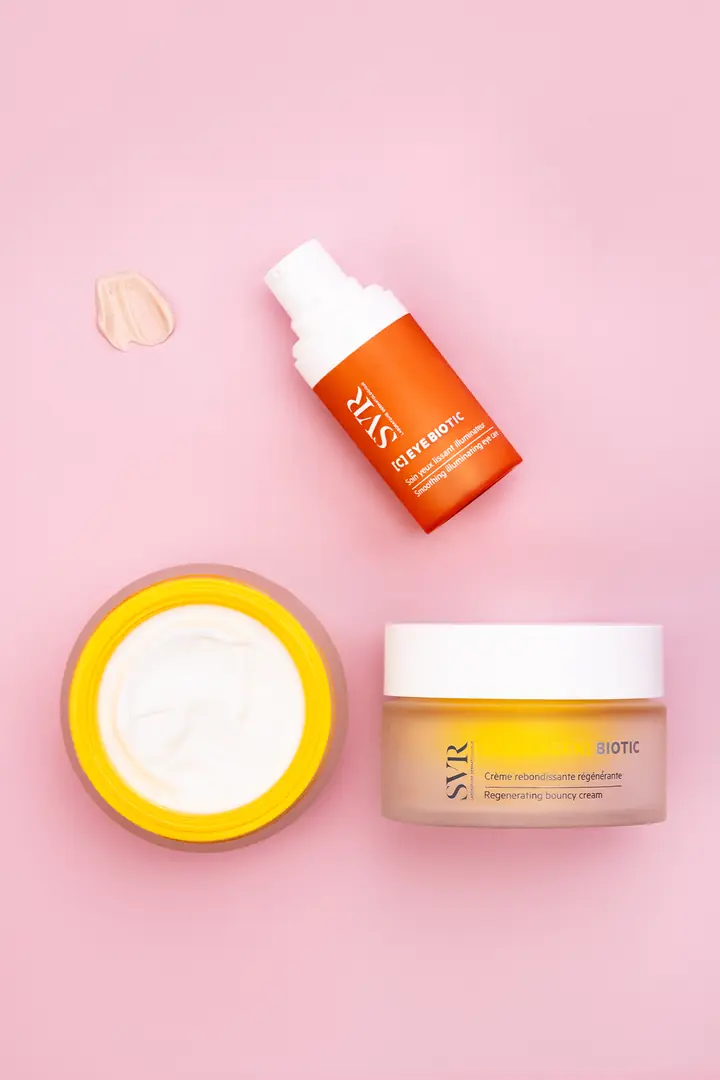 SVR [C] Eye Biotic and Collagen Biotic cream arranged on pink with a swatch of cream