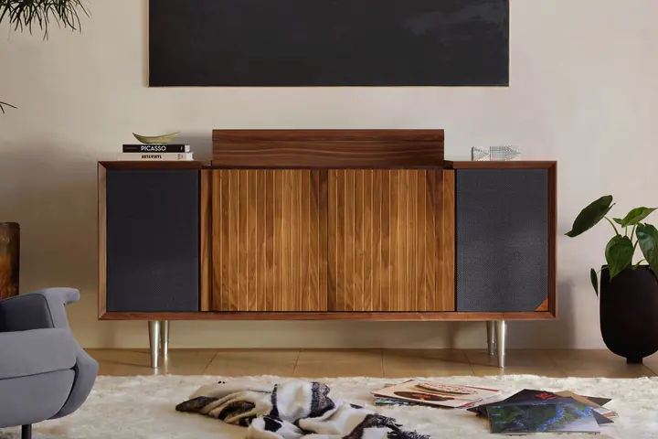 A walnut Wrensilva M1 console in a cream living room with records spread across the rug