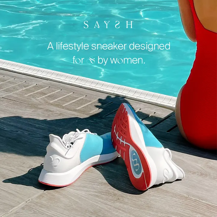 Saysh sneakers poolside with a red towel